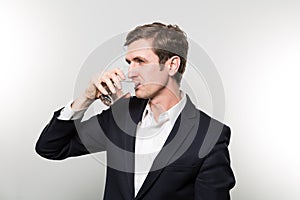 Studio shot of businessman with a glas of sparkling water