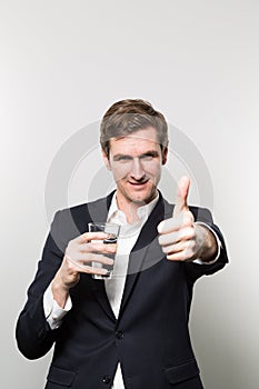 Studio shot of businessman with a glas of sparkling water