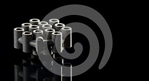 Gray textured mechanical part reflects on black