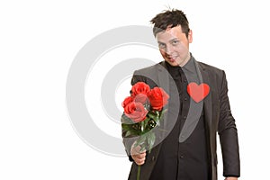 Studio shot of Caucasian businessman giving red roses ready for