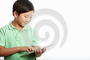Studio Shot Of Chinese Boy With Digital Tablet