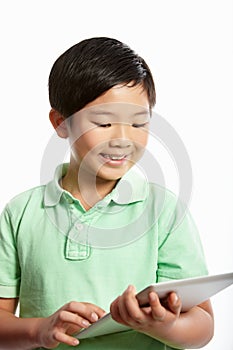 Studio Shot Of Chinese Boy With Digital Tablet