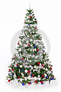 Studio shot of a Christmas tree with blue, red and white ornaments, isolated on a white background