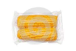 Studio shot of corns packed with plastic vacuum package on white background