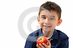 Studio shot of cute happy boy smiling and holding red apple