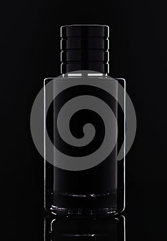 Studio shot of dark Glass perfume bottle on black background with perfect lighting
