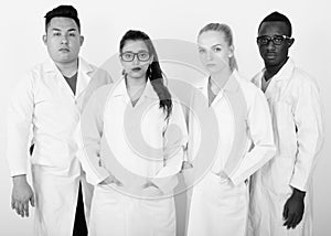 Studio shot of diverse group of multi ethnic doctors standing together