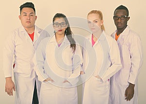 Studio shot of diverse group of multi ethnic doctors standing together