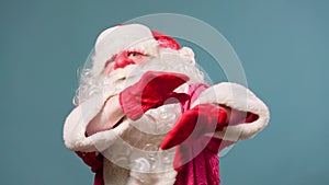Studio shot front view cheerful Santa Claus half body dances, gesticulating active with his hands.