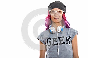 Studio shot of geek girl wearing eyeglasses with headphones arou