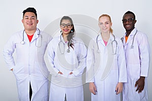 Studio shot of happy diverse group of multi ethnic doctors smili