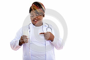 Studio shot of happy fat black African woman doctor smiling whil