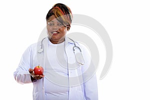 Studio shot of happy fat black African woman doctor smiling whil