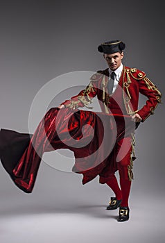 Studio shot of man dressed as Spanish matador