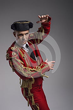 Studio shot of man dressed as Spanish matador