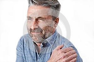 Studio Shot Of Man Suffering With Frozen Shoulder photo