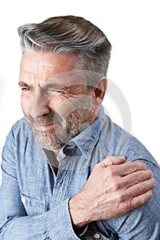 Studio Shot Of Man Suffering With Frozen Shoulder photo