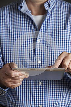 Studio Shot Of Man Using Digital Tablet