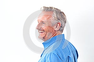 Studio Shot Of Mature Man Against White Background Laughing At Camera