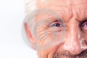 Studio Shot Of Mature Man Cropped On Eyes Against White Background Smiling At Camera