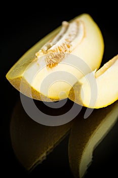 Studio shot of notched ripe melon galia with slice