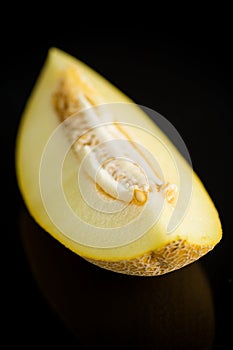 Studio shot of notched ripe melon galia with slice