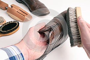 Studio shot of old, weary, little scratched cap toe lace op oxford leather shoes in burnished brown color on white