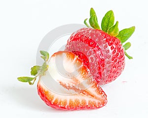 Studio shot one whole organic strawberry with a half cut isolated on white