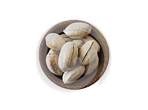 Studio shot of pecans on white background. Pecans in nutshell on wooden bowl isolated on white. Pecans with copy space for text.