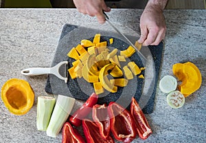 studio-shot of preparing lunch for the family. cooking pumpkin soup in a modern kitchen