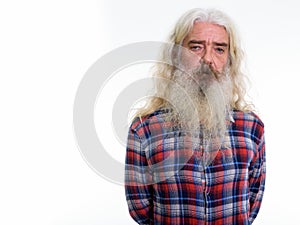 Studio shot of senior bearded man with gray beard and long hair