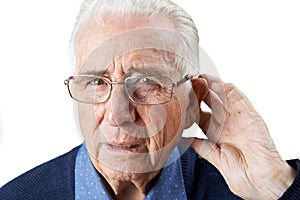 Studio Shot Of Senior Man Suffering From Deafness