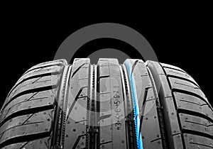 Car tire isolated on black background. Tire stack. Car tyre protector close up. Black rubber tire. Brand new car tires. Close up b