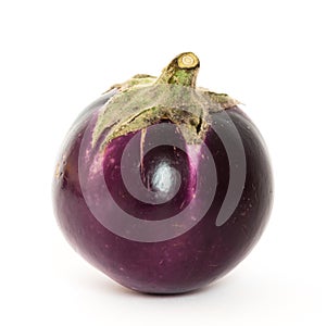 Studio shot of single organic violet round Thai eggplant isolated on white