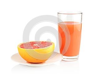 Studio shot sliced grapefruit on plate with juice isolated white