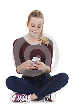 Studio Shot Of Teenage Girl Sending Text Message
