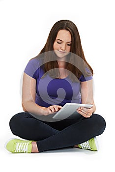 Studio Shot Of Teenage Girl Using Digital Tablet