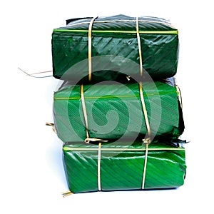 Studio shot three Chung Cakes square sticky rice cake Vietnamese New Year food isolated on white