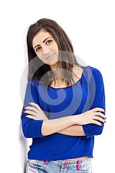 Studio shot of a trendy beautiful teenage girl with arms folded