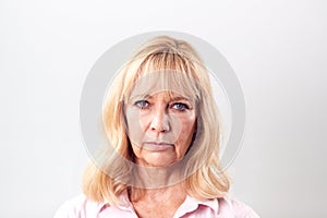 Studio Shot Of Unhappy And Frustrated Mature Woman Against White Background At Camera