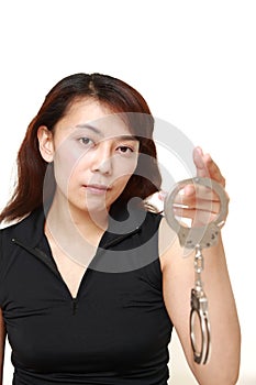 Studio shot of an woman with handcuffs