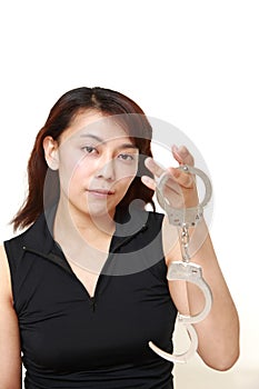 Studio shot of an woman with handcuffs