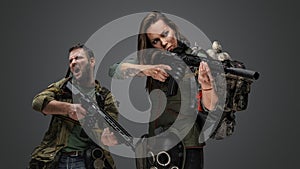 Mad man and woman in fight stance aiming rifle