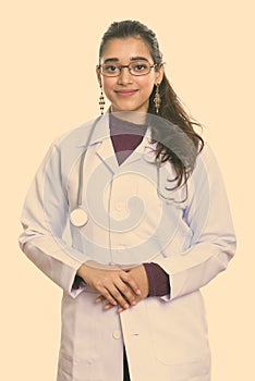 Studio shot of young beautiful Indian woman doctor