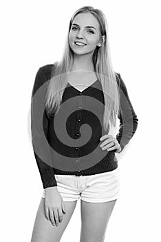 Studio shot of young happy teenage girl smiling while posing