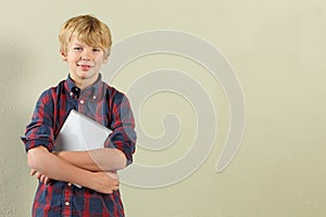 Studio Shot Of Young Boy Holding Tablet Computer