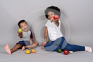 Young cute African siblings together against gray background photo