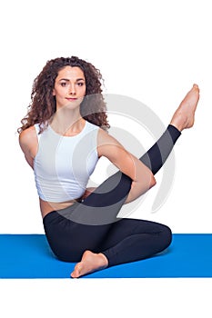 Studio shot of a young fit woman doing yoga