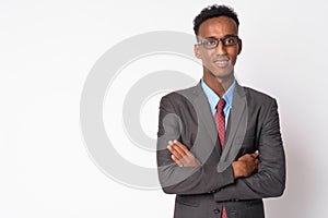 Young happy African businessman with eyeglasses smiling