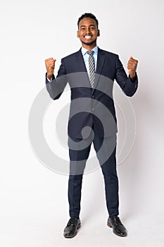 Full body shot of happy young African businessman getting good news